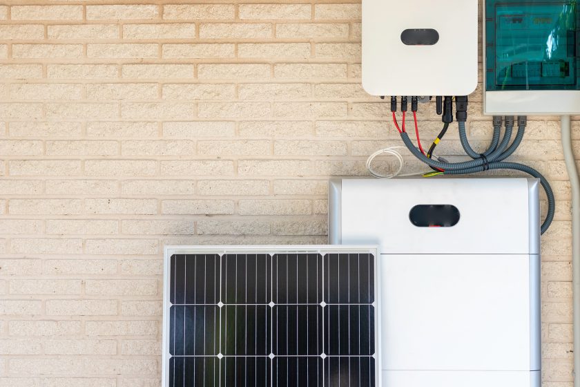 Solar panel, inverter, and battery displayed next to each other.